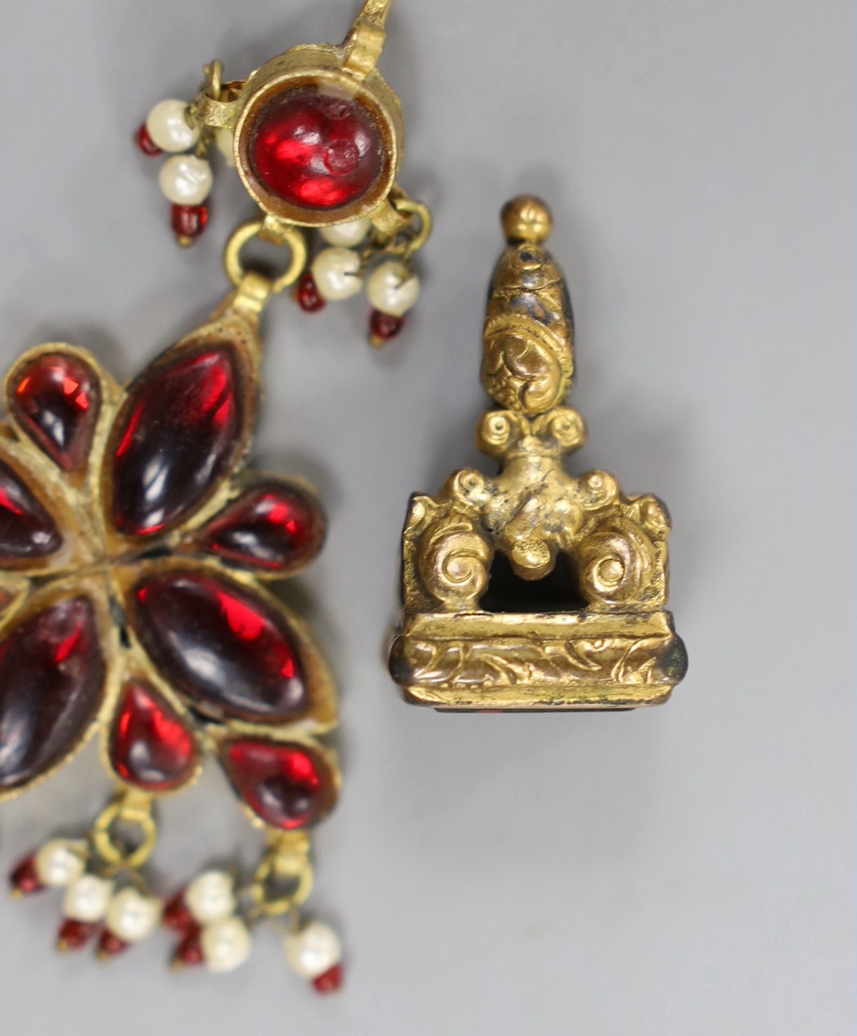 A gilt metal and bloodstone set fob seal, 30mm and a gilt metal, red paste and simulated seed pearl set drop pendant.